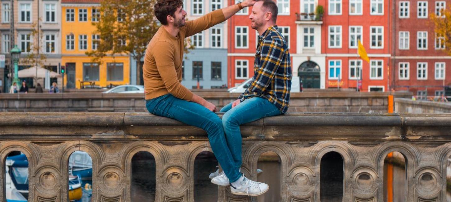 Gay couple sits at the canals in Copenhagen