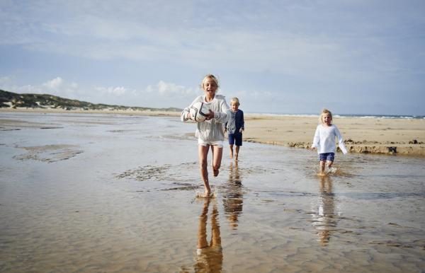 Kids running on Saltum Beach in North Jutland