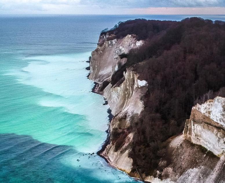 Møns Klint, a cliff in Southern Denmark, seen from above, with turquoise waters